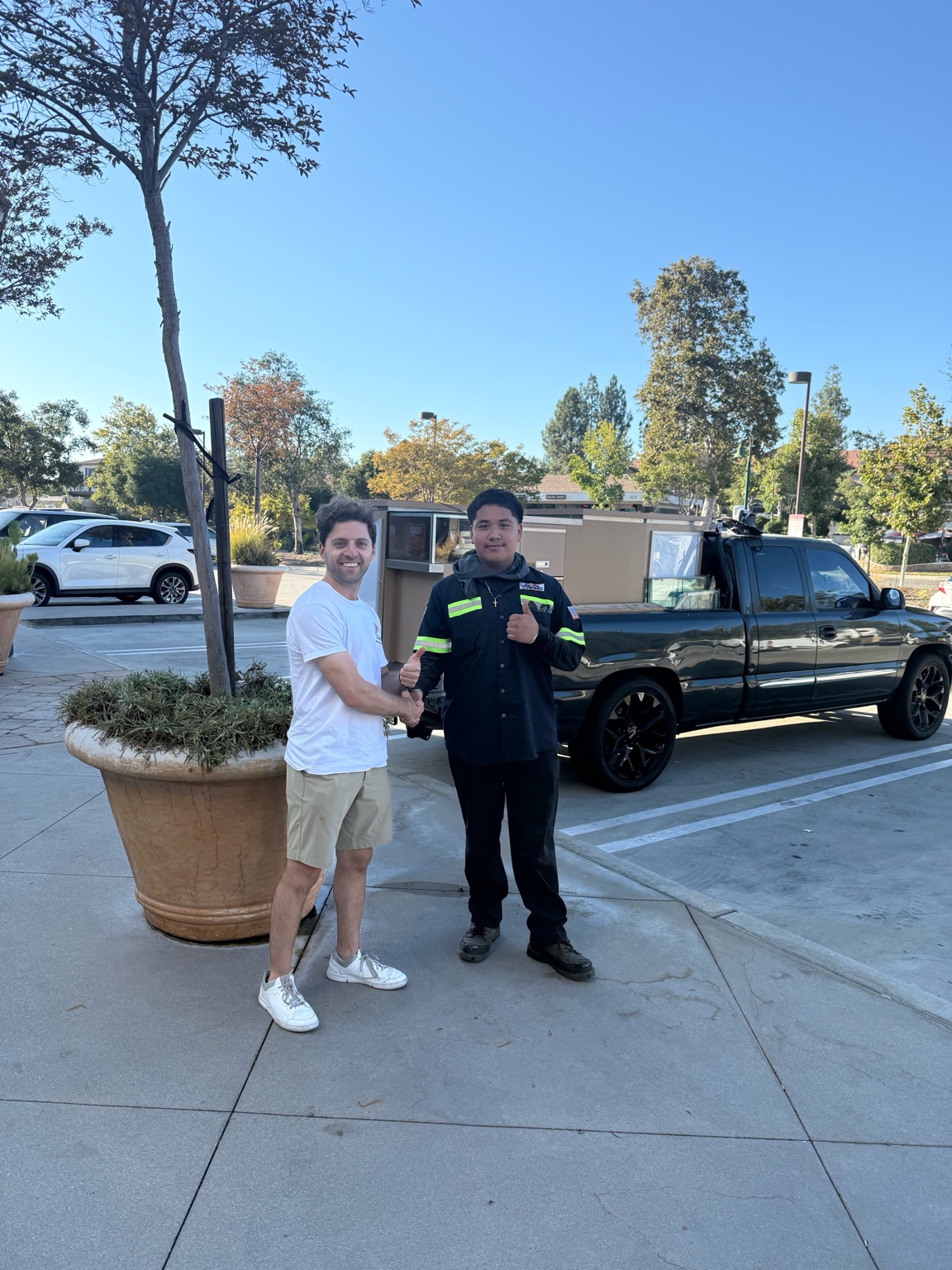 Happy customer handshake after a successful junk removal